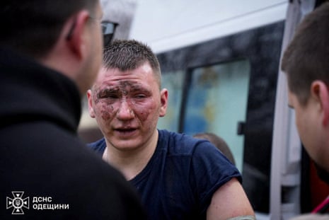 An injured rescuer is seen at the site of a Russian missile strike in Odesa on 15 March.