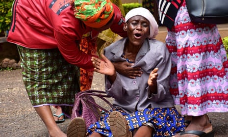 A woman is consoled after the her granddaughter died in the crush during a church service in Moshi, north Tanzania.