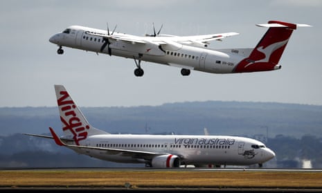 Qantas and Virgin planes. The Qantas plane is mid-air as the Virgin plane taxis on the ground