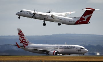 AUSTRALIA-BUSINESS-QANTAS<br>A Virgin Airways plane travels down the runway as a QantasLink Dash 8-400 series plane takes off at Sydney's Kingsford Smith international airport on November 3, 2023. (Photo by DAVID GRAY / AFP) (Photo by DAVID GRAY/AFP via Getty Images)
