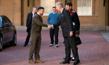 Ukrainian President Volodymyr Zelenskiy is greeted by Sir Clive Alderton, principal private secretary to King Charles III, as he arrives for an audience with the King at Buckingham Palace.