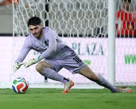 Debutant Patrick Beach dives to make a save