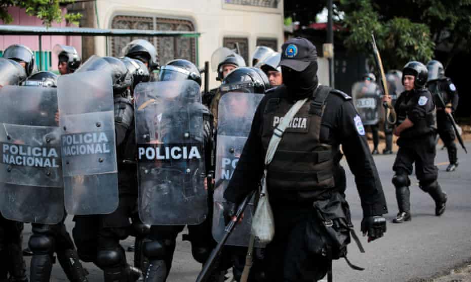 Riot police patrol the streets during a protest against Daniel Ortega in Managua.