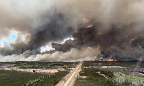 Smoke rising from mutual aid wildfire HTZ001 which flared due to strong winds, near Indian Cabins, Alberta, Canada, in May 2024.