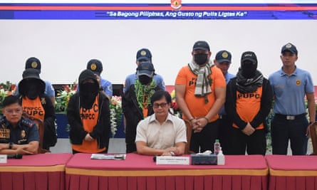 Apollo Quiboloy (2nd R), Philippine pastor and founder of the Philippines-based Kingdom of Jesus Christ (KOJC) church, and co-accused (in orange) are presented to members of the media during a press conference inside the national police headquarters in Manila on September 9, 2024.