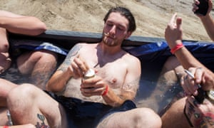 Festival goer Alic drinks a beer in a makeshift pool in a pickup bed during Audiofeed Festival in Urbana, Illinois on Saturday, July 1, 2017. The party was later broken up by security; Audiofeed is an alcohol-free festival.