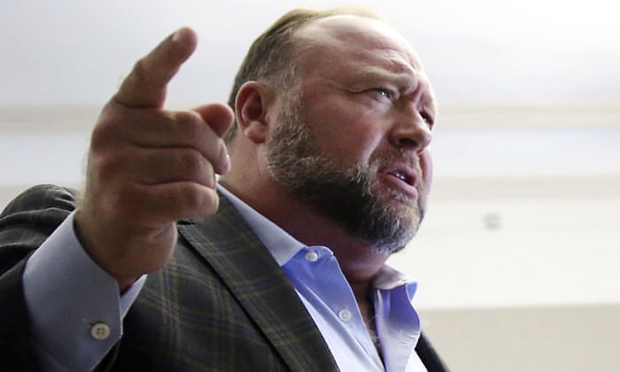 Alex Jones talks to media during break in his trial in Texas in July.
