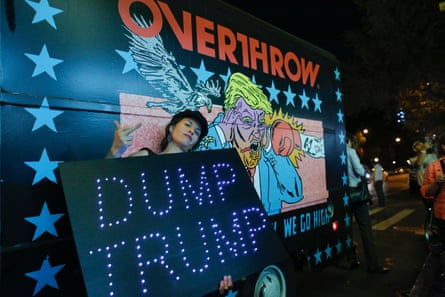 A woman poses next to the the “Knockout Trump Truck” outside the IFC Theater