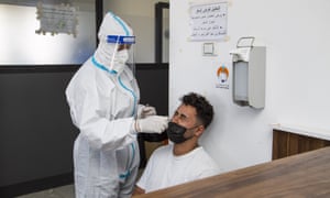 Covid live news: UK reports 31,772 daily infections and 26 new deaths; new restrictions in Libya after record cases | World news 2 Covid-19 testing in Misrata, Libya today.