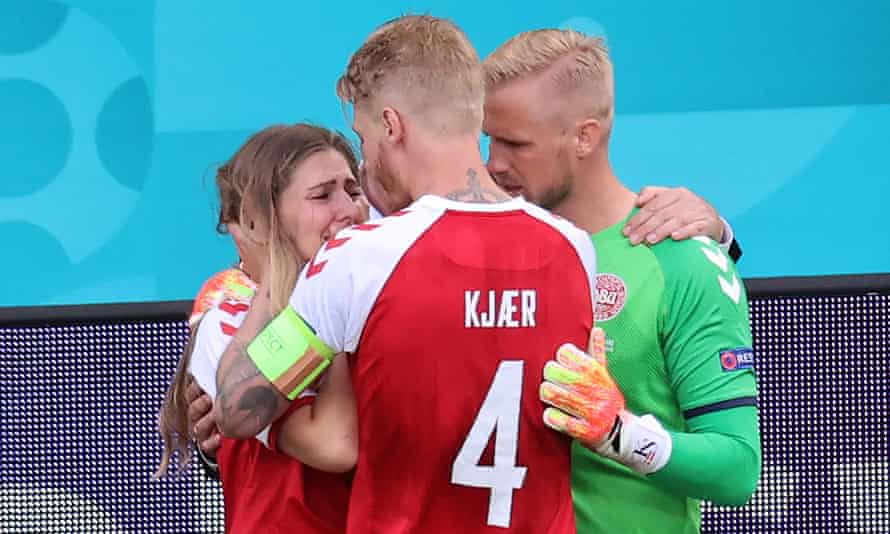 Simon Kjær comforts Sabrina Kvist Jensen, Christian Eriksen’s wife, with Kasper Schmeichel’s assistance.