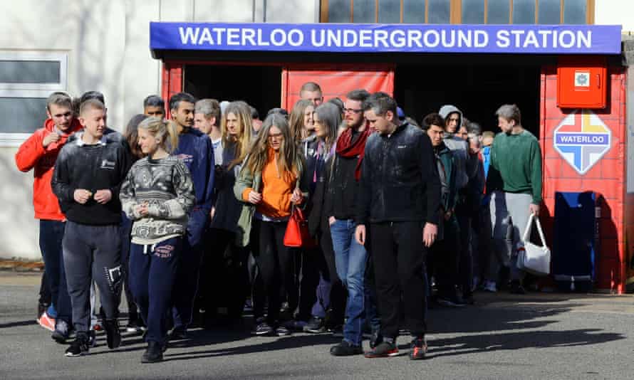 People posing as disaster victims exit the reconstructed Waterloo tube station.