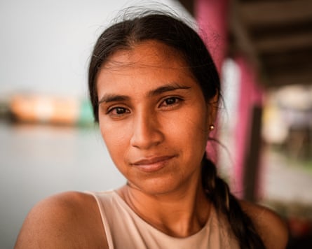 A young Latina woman poses by water