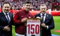 Robert Lewandowski being presented with a memento of his 150th cap for Poland before the friendly win over Turkey