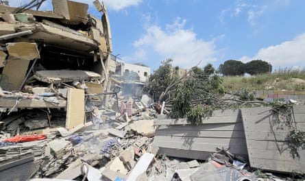 Trees lay on top of the wreckage