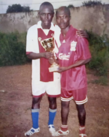 Mamadou, left, and his cousin Emmanuel, right, taken 25 years ago in Ivory Coast - before they left for Europe.