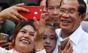 Garment workers take pictures with Cambodia’s Prime Minister Hun Sen