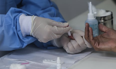 An antibody test requires a blood sample from a patient’s fingers.