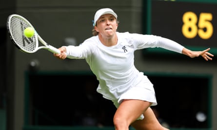 Iga Swiatek plays a forehand during the first round match against Zhu Lin at Wimbledon.