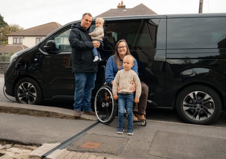 Gregg and Lauren Francis and their sons in front of a van outside their home in Wales.