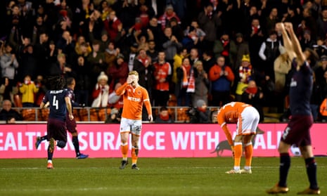 Blackpool players seem dejected after Arsenal’s Alex Iwobi scored the third goal of the game.