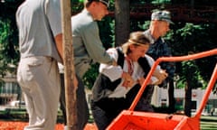FILE - Belarusian security officers detain Ales Pushkin, an artist and opposition activist, after he brought a wheelbarrow filled with manure and dumped it in front of President Alexander Lukashenko's office in Minsk, Belarus, July 21, 1999. The Belarusian artist has died in a prison, where he was serving a five-year sentence, human rights activists and his wife said Tuesday July 11, 2023 (AP Photo/File)
