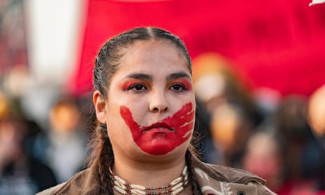 A demonstrator displaying a symbol of solidarity with missing and murdered Indigenous women and girls.