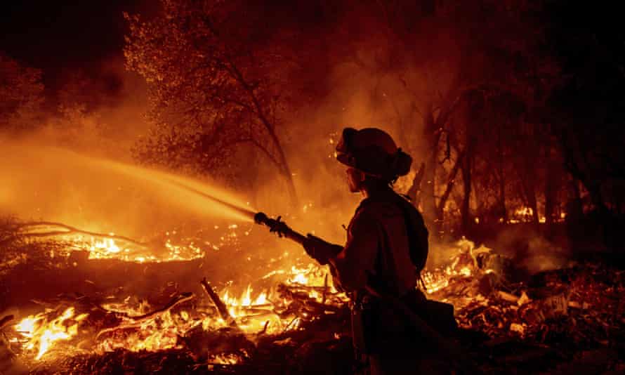 A firefighter battles the Fawn fire in Shasta county on 23 September.