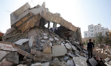 A Yemeni walks through the debris of a destroyed building in Sana'a, Yemen.
