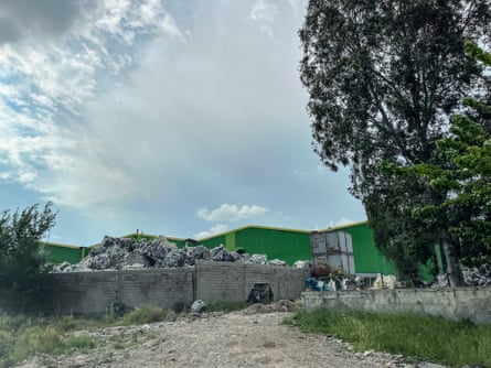 A huge pile of rubbish outside a factory building