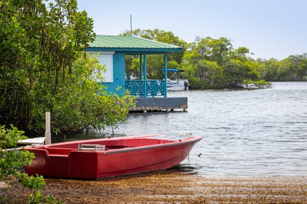 A red boat and blue boathouse in La Parguera.