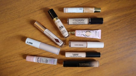 Ten tubes of concealer on a table top