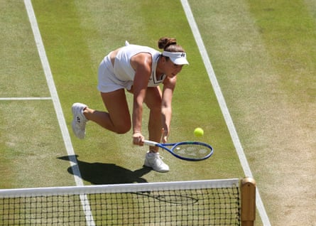 Linda Noskova chases a drop shot from Elise Mertens