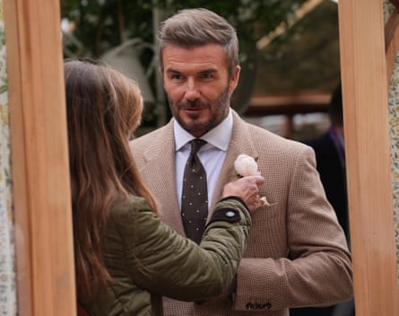 David Beckham having the new rose named after him pinned to his button hole at the RHS Chelsea flower show.
