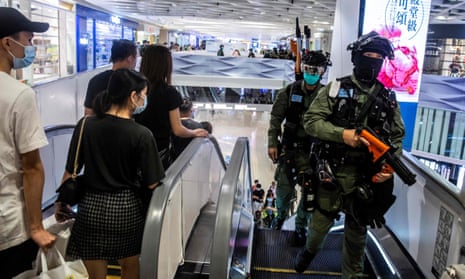 Hong Kong riot police attend a protest inside a mall at Yuen Long i