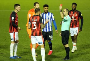 Bournemouth’s Steve Cook is shown a red card by referee Jeremy Simpson for his foul on Sheffield Wednesday’s Joey Pelupessy