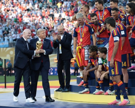 Gianni Infantino and Donald Trump carry the World Cup trophy to the Spain team