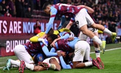 Michael Obafemi is buried under his Burnley teammates after his late equaliser against Watford.