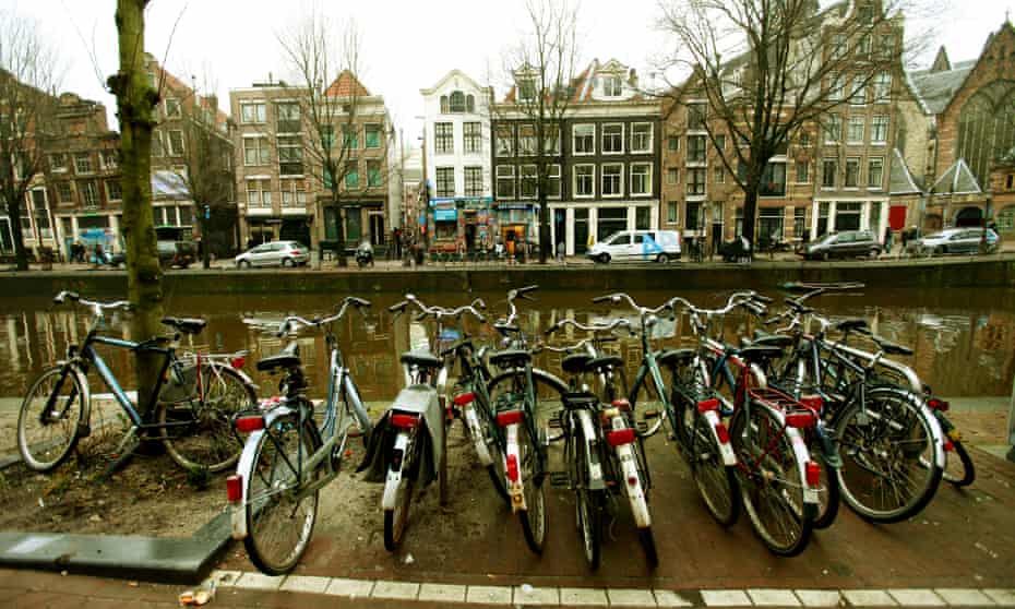Bicycles parked by a canal in Amsterdam