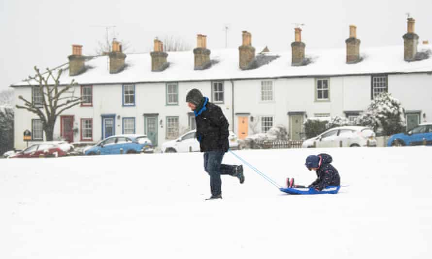 Frank Simon pulls his daughter Anna, aged six, through the snow in Bessels Green near Sevenoaks in Kent