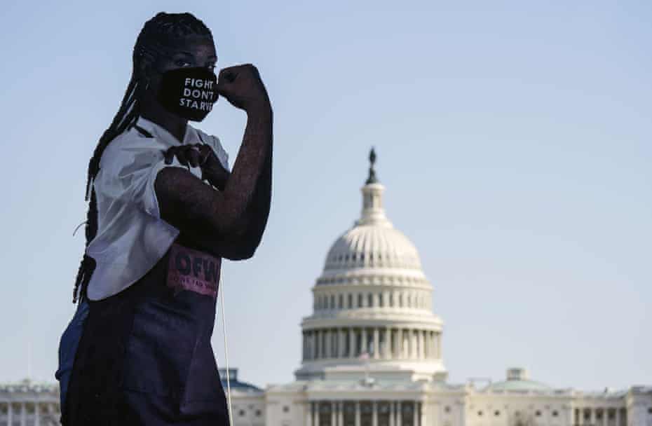 A statue of “Elena the Essential Worker” is seen at a One Fair Wage and the Poor People’s Campaign rally, in the $15 minimum wage privision of the Covid relief bill in Washington lat month.