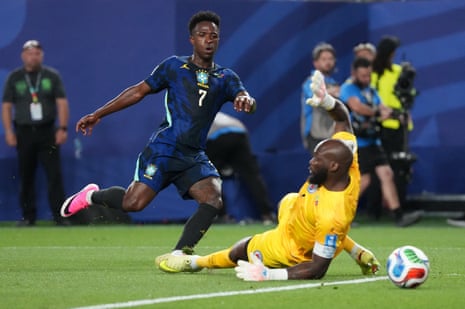 Vinicius Junior beats Johny Placide for Brazil’s third goal.
