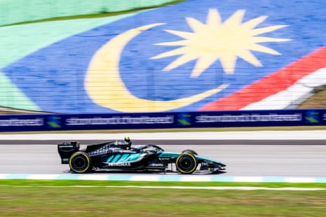 Kimi Antonelli drives past a Malaysian flag.