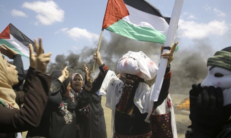 Palestinian women wave national flags and chant slogans near the Israeli border fence, east of Khan Younis, in the Gaza Strip, Monday, May 14, 2018. Thousands of Palestinians are protesting near Gaza's border with Israel, as Israel prepared for the festive inauguration of a new U.S. Embassy in contested Jerusalem. (AP Photo/Adel Hana)