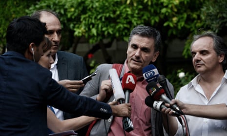 Greek finance minister Euclides Tsakalotos talks with reporters.
