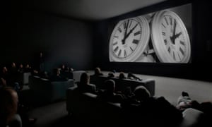 An audience watching The Clock.