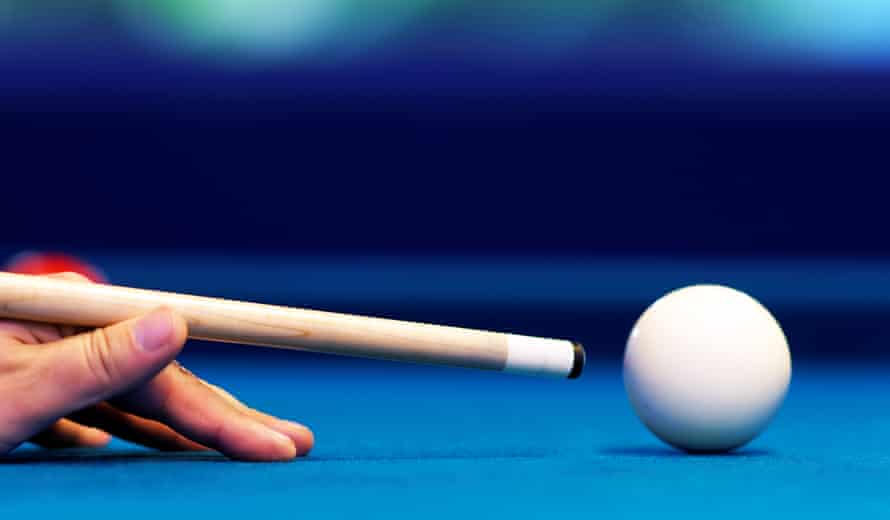 Cropped hand of man playing pool
