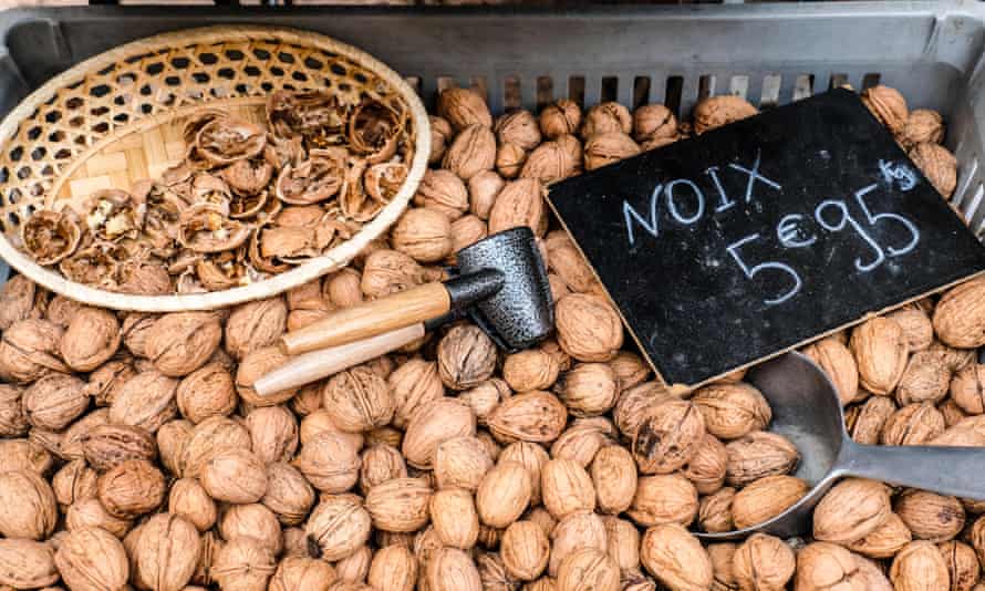 Walnuts and walnut cracker for sale at farmers market in France