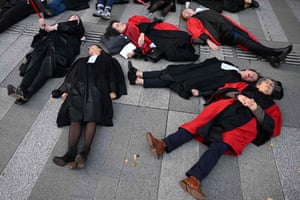 Paris, France. Magistrates lie on the ground during a protest at the Batignolles courthouse against a planned overhaul of the judicial system