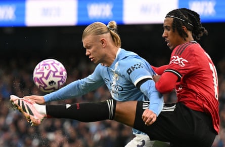 Manchester City’s Erling Haaland tries to hold off Manchester United’s Leny Yoro.