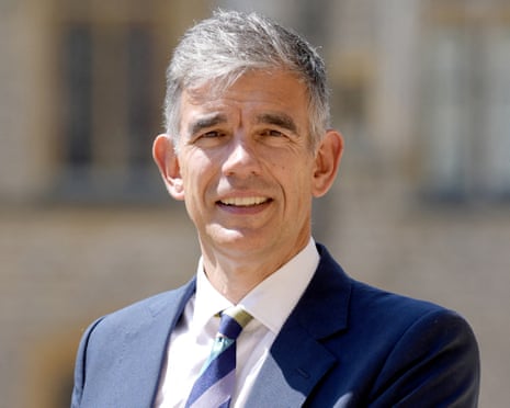 Matt Brittin in a blue suit and striped tie poses outdoors